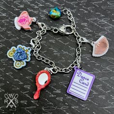 Introducing Bestie Charm Club! Get ready to add some charm to your life with our playful and colorful charms. Perfect for collecting and adding a special touch to your outfit. Reminisce about the 80's with our exclusive charms on a charm bracelet or necklace. Join the club now! This bracelet includes a special edition Czech Crystal embellishment and all 5 charms in the Spill the Tea Collection: -Teapot -Hand Mirror -Hand Fan -Dance Card -Royal Carriage Tell your story and show what you love thro Cute Nickel-free Charm Bracelet For Friendship, Playful Multicolor Jewelry With Removable Charms, Fun Charms Jewelry For A Gift, Fun Charms Jewelry As Gift, Playful Charms Jewelry For Birthday, Novelty Multicolor Charm Bracelet, Cute Multicolor Jewelry With Removable Charms, Playful Metal Jewelry For Gifts, Playful Metal Jewelry Gift