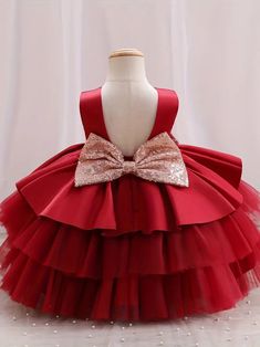 Make your little one the belle of the ball with this classic red princess gown. The dress boasts a sleek, sleeveless top and a plush, multi-layered tulle skirt that's made for twirling. A shimmering gold bow adorns the waist, providing a beautiful contrast to the deep red. It's an ideal choice for flower girls, birthday parties, or any event where making a statement is a must. Size Chart Size Chart US Shoulder (inches) Bust size (inches) Waist size (inches) Length (inches) 6-9M 7.9 20.5 19.7 17. Christmas Sleeveless Ball Gown For Dress-up, Sleeveless Christmas Ball Gown, Christmas Tulle Princess Dress For Fancy Dress, Princess Tulle Holiday Dress For Christmas, Princess Style Tulle Holiday Dress For Christmas, Elegant Christmas Tutu Dress In Tulle, Elegant Christmas Tutu Dress For Fancy Dress, Elegant Christmas Tulle Tutu Dress, Elegant Tulle Ball Gown For Christmas