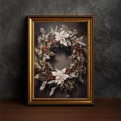 a framed christmas wreath with holly and berries on it in front of a gray wall