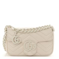 This is an authentic GUCCI Calfskin Matelasse Monochrome GG Marmont Chain Belt Bag in Mystic White.This belt bagis crafted of smooth and supple calfskin leather in ivory. This bag features a long adjustable white ceramic-effect chainbelt strap. The front crossover flapfeatures a matching interlocking white GG logo and opens to a beige microfiber interior with a silver key ring. Gucci Crossbody Bag White, Gucci Wallet White, Silver Key, Gg Logo, Gg Marmont, Chain Belt, Belt Bag, Key Rings, Key Ring