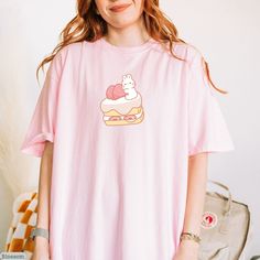 Kawaii Bunny With Strawberry Cake Comfort Colors® Shirt, Kawaii Graphic Tee, Kawaii Clothing, Kawaii Aesthetic Shirt, Kawaii Food Shirt 🍓Comfort Colors 1717 Unisex T-shirt🍓 ✨ SIZE GUIDELINES ✨ - This shirt fits true to size - If you want a comfortably fitted look, I recommend sticking with your regular t-shirt size - If you want a slightly oversized fit, I recommend sizing up one size - If you want a true oversized fit, I recommend sizing up two to three sizes ✨ You can contact me for more col Pink Crew Neck T-shirt With Cute Design, Kawaii Cute Crew Neck Tops, Cute Kawaii Crew Neck Top, Kawaii Crew Neck Top With Cute Design, Kawaii Funny Print Crew Neck T-shirt, Kawaii T-shirt With Funny Print And Crew Neck, Pink Funny Print Kawaii Tops, Kawaii Hello Kitty Short Sleeve T-shirt, Pink Kawaii Top With Funny Print