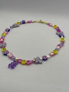 a necklace with smiley faces and hearts on it