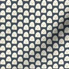 a black and white wallpaper with lots of ghost heads on it's side