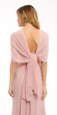 the back of a woman wearing a pink dress with a large bow on it's shoulder