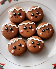 six gingerbread cookies decorated with icing on a plate