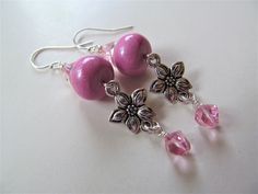 Pretty in pink! These earrings are made with pink polymer clay beads handcrafted by Crafts by Chris. Pink Swarovski crystals sparkles above and dangles below a silver tone flower charm. The earwires are genuine sterling silver. Length of the dangled earring is approximately 1.75". From the top of the earwire to the bottom bead is about 2.25".  50% from the sale of these earrings will go to benefit animal awareness causes. Please see my shop announcement for details:  https://www.etsy.com/shop/Be Pink Dangle Beaded Earrings With Spacer Beads, Handmade Pink Flower Earrings With Round Beads, Nickel-free Pink Beaded Earrings, Pink Beaded Czech Glass Earrings, Pink Flower Earrings With Dangling Round Beads, Pink Flower-shaped Jewelry With Dangling Beads, Pink Flower Jewelry With Dangling Beads, Pink Dangling Bead Flower Earrings, Pink Dangling Beads Flower Drop Earrings