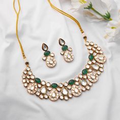 Exude timeless charm with this classic and elegant kundan set, adorned with captivating emerald stones and finished in gold-plated metal. Perfect for adding a touch of sophistication to any ensemble, this set is a timeless addition to your collection. Finish: 22KT Gold Plating Material: Brass, Kundan, Emerald Color: Gold, White & Green Size: Free Size, Adjustable Closure Type: Draw String Box Contains: 1 Necklace, 1 Pair Earrings Hand Jewelry Rings, Chain Braid, Kundan Necklace Set, Traditional Indian Jewellery, Kundan Set, Fabric Pouch, Perfume Store, Indian Wedding Wear, Kundan Necklace