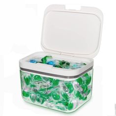 an ice chest filled with lots of green and blue gummy bears in it's lid