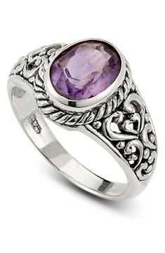 An oval amethyst adds sparkling detail to a class ring inspired piece that is fashioned from etched sterling silver. Sterling silver/amethyst Imported Silver Amethyst Ring With Oval Accent Stones, Oval Silver Amethyst Ring, Oval Amethyst Ring With Gemstone Accents In Sterling Silver, Oval Amethyst Ring In Silver, Classic Silver Amethyst Oval Cabochon Ring, Classic Silver Oval Cabochon Amethyst Ring, Classic Silver Amethyst Ring Oval Cabochon, Classic Silver Amethyst Ring With Oval Cabochon, Silver Oval Amethyst Ring