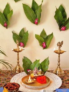 a table topped with plates filled with food next to candles and flowers on top of it