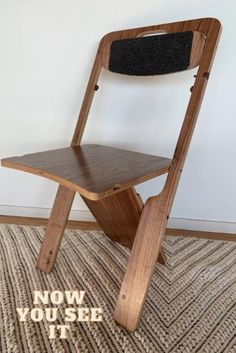 a wooden chair sitting on top of a rug