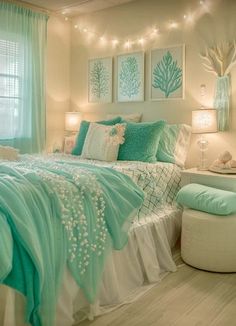 a bedroom decorated in aqua and white colors