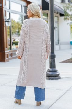 Wrap yourself in cozy comfort with our Chunky Cable Knit Duster Cardigan in a soft light beige hue! Designed for the free-spirited and effortlessly chic, this longline cardigan is the perfect layering piece for any boho-inspired look. Crafted from a chunky cabe knit material, this duster cardigan offers maximum coziness, giving you that wrapped-in-a-blanket feel with a stylish twist. Perfect for layering during those crisp fall mornings or cool evenings, this cardigan is an essential for any boh Long Beige Sweater For Winter, Long Beige Winter Sweater, Long Cream Cardigan For Winter, Beige Long Knit Outerwear, Trendy Cream Soft Knit Outerwear, Long Beige Knit Outerwear, Beige Long Soft Knit Sweater Coat, Long Beige Soft Knit Sweater Coat, Long Beige Soft Knit Outerwear