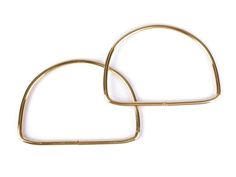 pair of gold hoops on white background with clipping in the shape of heart