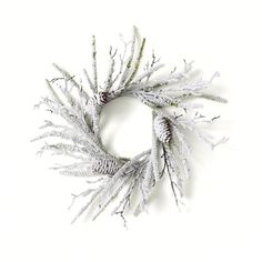 a wreath made out of white branches and pine cones on a white background with copy space