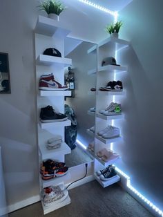 there is a closet with many shoes on the shelves and lights in the room behind it