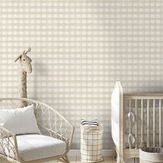 a baby's room with a crib, rocking chair and giraffe wallpaper