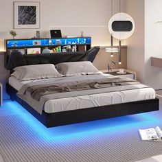 a bed that has some lights on the headboard and foot board in front of it