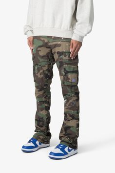 the Bootcut Cargo Pants are designed with our new B fit, which is slim through the thigh and features a slight flare at the leg opening and is constructed from washed camo twill, with a vintage wash and paint splatter, and finished with a contrasting camo panelling. details flare at leg opening 100% cotton model is 6’1 Urban Camouflage Straight Leg Cargo Pants, Camouflage Straight Leg Jeans For Streetwear, Urban Camouflage Jeans For Streetwear, Camouflage Straight Leg Cotton Cargo Jeans, Fitted Camouflage Cargo Pants For Streetwear, Fitted Camouflage Cotton Jeans, Fitted Camouflage Cargo Pants With Straight Leg, Casual Paint Splatter Streetwear Bottoms, Urban Style Cotton Bottoms With Paint Splatter