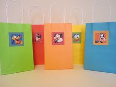 four colorful bags with mickey mouse pictures on them