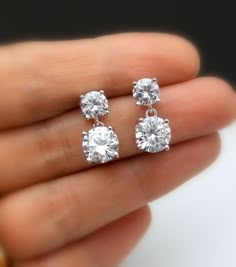 Tarnish resistant White gold plated metal framed AAA high quality clear white cubic zirconia round post earrings with AAA quality round drop clear white cubic zirconia pendant. Earring posts are surgical steel.. Size: top stone diameter: 6mm Bottom stone diameter: 8mm Matching necklace and bracelet available. https://www.etsy.com/listing/278176308/diamond-quality-solitaire-necklace-cubic?ref=listings_manager_grid https://www.etsy.com/listing/85607281/bridal-wedding-bracelet-christams?ref=shop_ho Simple Wedding Earrings, Small Earrings Gold, Diamond Charm Necklace, Round Diamond Earrings, Diamond Solitaire Earrings, Diamond Earrings Design, Solitaire Earrings, Jewelry Bridesmaid, Diamond Jewelry Designs