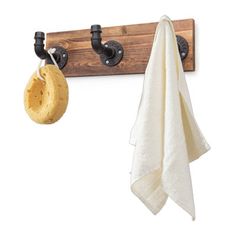 a towel hanging from a hook on a coat rack next to a pair of shoes