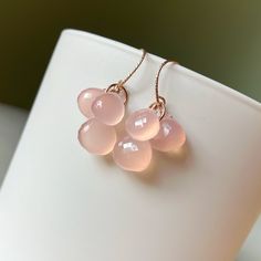 Beautiful pink chalcedony briolettes gather on 14k rose gold filled rings.   Earrings are finished with rose gold filled earwires. Chalcedony hearts measure 9-10mm. Total earring length is 1.25 inches. Please note that pictures of my jewelry are enlarged. The gemstone colors may vary on the device being used to view items. I do not alter the gemstone colors in my photos, but the backdrop can alter their look. My practice is always to add my jewelry last before heading out and to remove my jewelry first after returning home. Here are a few other jewelry care tips: Avoid direct contact with perfume, hairspray or other chemicals. Remove jewelry when bathing, showering or swimming. Remove jewelry when participating in sports and physical activities. Remove jewelry before going to bed. Clean yo Delicate Rose Gold Briolette Jewelry, Faceted Briolette Rose Gold Jewelry, Faceted Rose Gold Briolette Jewelry, Rose Gold Faceted Briolette Jewelry, Rose Gold Dangle Earrings With Rose Quartz, Rose Gold Faceted Dangle Earrings, Rose Gold Drop Earrings With Gemstones, Rose Gold Rose Quartz Drop Earrings, Delicate Rose Gold Drop Earrings