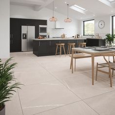 an open kitchen and dining room with white tile flooring