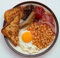 a plate with eggs, toast, beans and sausage