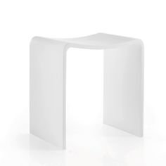 a white table sitting on top of a white floor