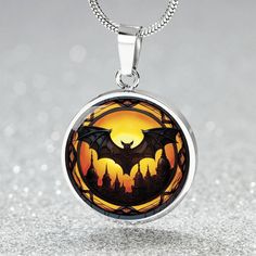 Embrace the darkness with our Personalized 18K Gold Vampire Bat Necklace. This charm pendant is the ultimate accessory for Gothic enthusiasts and Halloween lovers, adding the perfect touch of mysterious allure to your animal jewelry collection. ➜ Our patent-pending jewelry is made of high quality surgical steel with a graphic image that's printed directly onto the steel surface with a shatterproof liquid glass coating and includes an 18k gold finish option. There are no Gems in this product. ➜ O Vampire Style Necklace For Halloween, Handmade Vampire Style Necklace For Gift, Fantasy Necklaces For Halloween Gift, Collectible Vampire Jewelry For Halloween, Gothic Gold Jewelry For Halloween, Sterling Silver Necklaces For Halloween Gift, Gothic Halloween Jewelry With Round Pendant, Black Collectible Necklace For Halloween, Fantasy Style Engraved Necklaces For Gifts