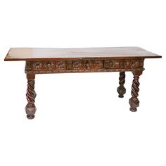 an old wooden table with carvings on the top and bottom, against a white background