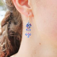 As whimsical and magical as your favorite constellation, the artisan-made dangling Firefly Mosaic Sapphire Earrings will bring a touch of sparkle and starlight to all of your favorite looks. They're delicate enough to be demure but unique enough to start a conversation: the perfect combination! • Sterling silver ear wires; setting is silver-plated antiqued steel• Clean with a soft jewelry polishing cloth. Never clean with any chemicals, chlorine, or bleach. To avoid damaging the finish, apply pe Fusion Style Chandelier Earrings As Gift, Fusion Style Dangling Beads Chandelier Earrings For Gift, Fusion Style Dangle Chandelier Earrings As Gift, Whimsical Drop Earrings With Dangling Charms, Whimsical Dangle Jewelry With Matching Earrings, Nickel Free Whimsical Drop Earrings, Nickel-free Whimsical Drop Earrings, Whimsical Nickel-free Drop Earrings, Whimsical Sterling Silver Earrings For Party