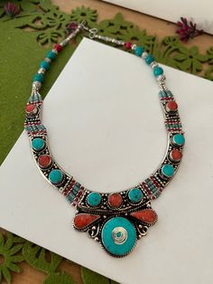 Complement your personality with this trendy unique design.  The gorgeous necklace is beautifully handcrafted by our skilled Indian craftsmen in stones and beads. Material: German Silver.  Weight of the necklace is 130 grams. Turquoise and coral. The length of the necklace when falls on the body is approximately 9 inches  Hook closure Traditional Turquoise Necklace With Colorful Beads For Gift, Spiritual Multicolor Turquoise Necklace For Festivals, Bohemian Gemstone Necklaces For Festive Occasions, Traditional Adjustable Turquoise Necklace With Natural Stones, Bohemian Turquoise Necklace With Red Coral For Gift, Festive Turquoise Necklaces With Colorful Beads, Red Bohemian Beaded Necklaces With Stones, Bohemian Red Beaded Necklaces With Stones, Handmade Red Coral Festive Jewelry