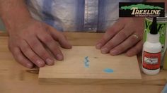 a man is making something with wood and glue