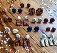 several pairs of earrings sitting on top of a wooden table