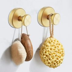 two wall mounted hooks holding different types of items