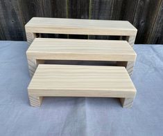 three wooden step stools sitting next to each other