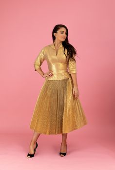 "A gorgeous 1950's Anita Bari of New York designer ensemble that will light up any room! This alluring matching set is made of an opulent metallic gold-lamé with a beautifully pleated skirt construction. This really gives the lamé depth and a bit of a soft sheen sparkle. The blouse has a chic collared plunge with 3/4-length sleeves. I love the hourglass nipped-waist design which flows into lined full swing-skirt. This is the type of look celebrity vixens, like Marilyn Monroe, made infamous. Extr Festive Fitted Evening Skirt, Festive Evening Fitted Skirt, Retro Fitted Skirt For Party, Vintage Fitted Evening Skirt, Elegant Pleated Gold Skirt, Elegant Full Skirt In Gold, Elegant Gold Pleated Skirt, Elegant Gold Full Skirt, Fitted Full Skirt Festive Dress