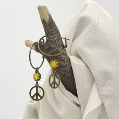 Unique bronze peace sign earrings. Fun, 70s style hippie earrings handmade with a yellow Czech glass flower bead. The dangle drop is made with a 15mm bronze peace sign and a 9mm yellow Czech glass flower bead with a Picasso edge. Casual everyday earrings. They are very lightweight, comfortable, and fun to wear. The bronze hoops are  1-inch in diameter (25mm), lead, and nickel-free with a lever back closure. The total earring length is 2 1/8 inches, measuring from the top of the hoop to the botto Vintage Summer Hoop Earrings, Vintage Metal Hoop Earrings For Summer, Summer Vintage Metal Hoop Earrings, Bohemian Dangle Hoop Earrings For Spring, Retro Dangle Earrings For Festivals, Bohemian Hoop Earrings For Spring Gift, Vintage Dangle Earrings For Spring, Bohemian Hoop Earrings As Spring Gift, Yellow Bohemian Metal Earrings