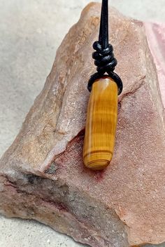 Tigers Eye stone necklace with adjustable cord. Perfect idea for gift. 1)-Stone size -18.5x17.5mm leather cord -2mm 1)-Necklace length 14"-28"(adjustable) --------------------------------------- 2)-Stone size -10.5x33mm (long shape) leather cord -2mm  (2)- necklace length 15"-30" adjustable (approx.) *Tiger Eye The zodiac stone for June, tiger's eye is in the quartz family. .it is, in fact, a good luck bringing stone that protects the wearing from evil thoughts and all ill wishes of enemies.it also possesses many healing properties. .Tiger Eye reduces the chronic pains, improves the strength of spines, and detoxifies the body. .It boosts up your confidence level. .It gets you mental clarity and decidedness. Brown Waxed Cord Necklace For Gift, Healing Waxed Cord Necklace With Adjustable Cord, Adjustable Brown Necklace For Gifts, Adjustable Brown Necklace For Gift, Minimalist Waxed Cord Jewelry As Gift, Brown Minimalist Necklace With Adjustable Cord, Minimalist Brown Necklace With Adjustable Cord, Handmade Cord Jewelry Gift, Spiritual Necklace With Adjustable Waxed Cord