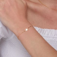 Discover the celestial charm with our 14K Gold Plated Solid 925 Sterling Silver Star Bracelet. This exquisite piece of jewelry is designed to add a touch of elegance and whimsy to your collection. Crafted from high-quality 925 sterling silver and plated with luxurious 14K gold, this bracelet combines durability with a radiant finish. Key Features: *Premium Materials: Made from solid 925 sterling silver and plated with 14K gold, ensuring a long-lasting, tarnish-resistant finish. *Celestial Design Dainty Star-shaped Bracelets For Everyday Wear, Everyday Star Charm Bracelet, Elegant Everyday Bracelets With Star Charm, Dainty Sterling Silver Bracelet With Star Charm, Dainty Star Charm Bracelet, Gift Chain Bracelet With Star Charm, Minimalist Bracelets With Star Charm, Celestial Bracelet, Silver Star Bracelet