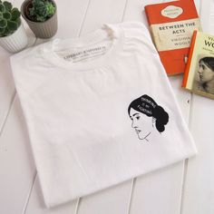 A loose fit unisex t-shirt screen printed with an illustration of Virginia Woolf. The perfect slogan tee for a book lover. 'Thinking is my fighting' - Virginia Woolf This hand drawn design has been screen printed in the South West of England, onto a soft white t-shirt which is made from 100% premium cotton. The relaxed fit top is a comfy, yet stylish item of clothing and makes a great literature themed gift for a book lover. Model (size 10) wears a size small and sleeves have been rolled back to Unisex White Print T-shirt With Screen Print, Unisex White Screen Printed T-shirt, Girl Power Tee, Feminist Tshirt, Screen Printed Tshirts, Slogan Shirts, Slogan T Shirt, Virginia Woolf, Strong Women Quotes