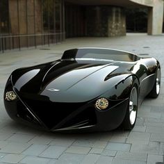 a black sports car parked in front of a building