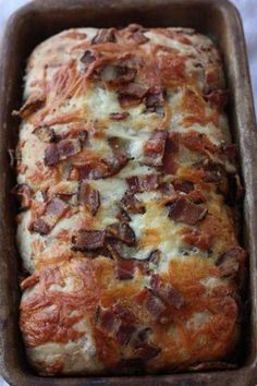 a loaf of bread with bacon on top