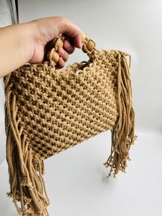 Add a different accessory to your wardrobe, make a statement with this eco-friendly Macrame Handbag while feeling confident you are helping your earth.  Natural, simple and light brown this unlined bag is handcrafted by artisans in India from up-cycled cotton denim and recycled material in intricate knotted patterns in the macrame style. Customisable in any color. Size- Width- 10 Inches (Without Tassel), Length- 8 inches Inches. Please let me know if you have any questions regarding any of my product. Bohemian Braided Rectangular Bag, Bohemian Braided Beige Bag, Bohemian Braided Jute Shoulder Bag, Eco-friendly Macrame Tote Shoulder Bag, Natural Straw Bag With Macrame For Everyday Use, Everyday Macrame Straw Tote Bag, Chic Macrame Rectangular Shoulder Bag, Eco-friendly Macrame Straw Bag, Beige Macrame Straw Bag