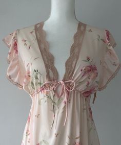 Stunning vintage 70s nightie/lingerie, and deadstock on top of it all! Adding a slip could easily turn it into a day dress. Still has original hang tags attached at the left arm. Sheer, nylon, adjustable in the under bust. Light pink, airy, dreamy ruffled shoulders. Flawless condition. Plenty of stretch.  Shoulders 15" Chest 19-21" (stretches) Ribs/underbust adjustable with tie Length (shldr to hem) 53" I would say this would suit anyone XS-M.  Super romantic and gorgeous! NEW ITEMS WEEKLY!  Come visit me on Instagram to have access to items before they are posted to the Etsy shop.  @rubyhausvintage All of the items I sell are pre-loved, which means that signs of wear are to be expected.  This brings unique character to an item! I do my best to note any major flaws I find in the item descr Sheer V-neck Coquette Sleepwear, Summer Coquette Sleepwear For Wedding Night, Coquette Sleepwear For Wedding Night In Summer, Feminine Sheer V-neck Sleepwear, Fitted Feminine Sleepwear For Night, Coquette Lace Trim V-neck Nightgown, Coquette V-neck Nightgown With Lace Trim, Feminine Sheer Sleepwear For Pajama Party, Coquette Lace Trim Sleepwear For Pajama Party