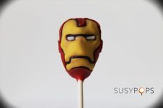 a red and yellow lollipop with a face drawn on it's side