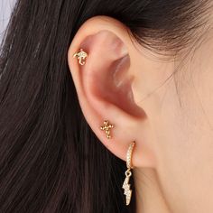 Designed with the shape of lightning, crafted in 14k gold with brass. The sparkling cz gems will definitely light up your whole piercing style and your outfit. Gold Dainty Cubic Zirconia Cartilage Earrings, Dainty Gold Cartilage Earrings With Cubic Zirconia, Gold Cubic Zirconia Huggie Cartilage Earrings, Gold Minimalist Cubic Zirconia Cartilage Earrings, Trendy Gold Internally Threaded Piercings, Adjustable Gold Cartilage Earrings In Cubic Zirconia, Gold Cubic Zirconia Tarnish-resistant Piercings, Gold Cubic Zirconia Piercings Tarnish Resistant, Dainty Gold-plated Piercings