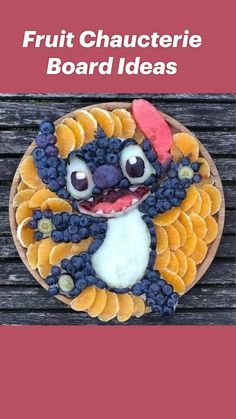 a cake decorated to look like a cartoon character with fruit on it's face